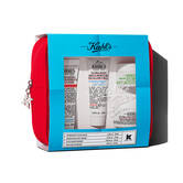 Set de regalo de viaje Kiehl's en estuche rojo. Incluye varios productos visibles a traves de una ventana con diseno en tonos azules.
