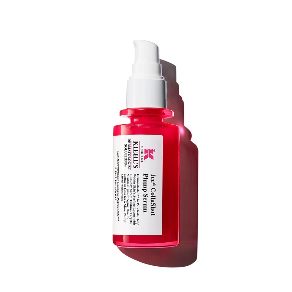 Botella roja de Kiehl's Hydro-Plumping Serum con dispensador blanco sobre fondo blanco, destacando su llamativo diseno y etiqueta.